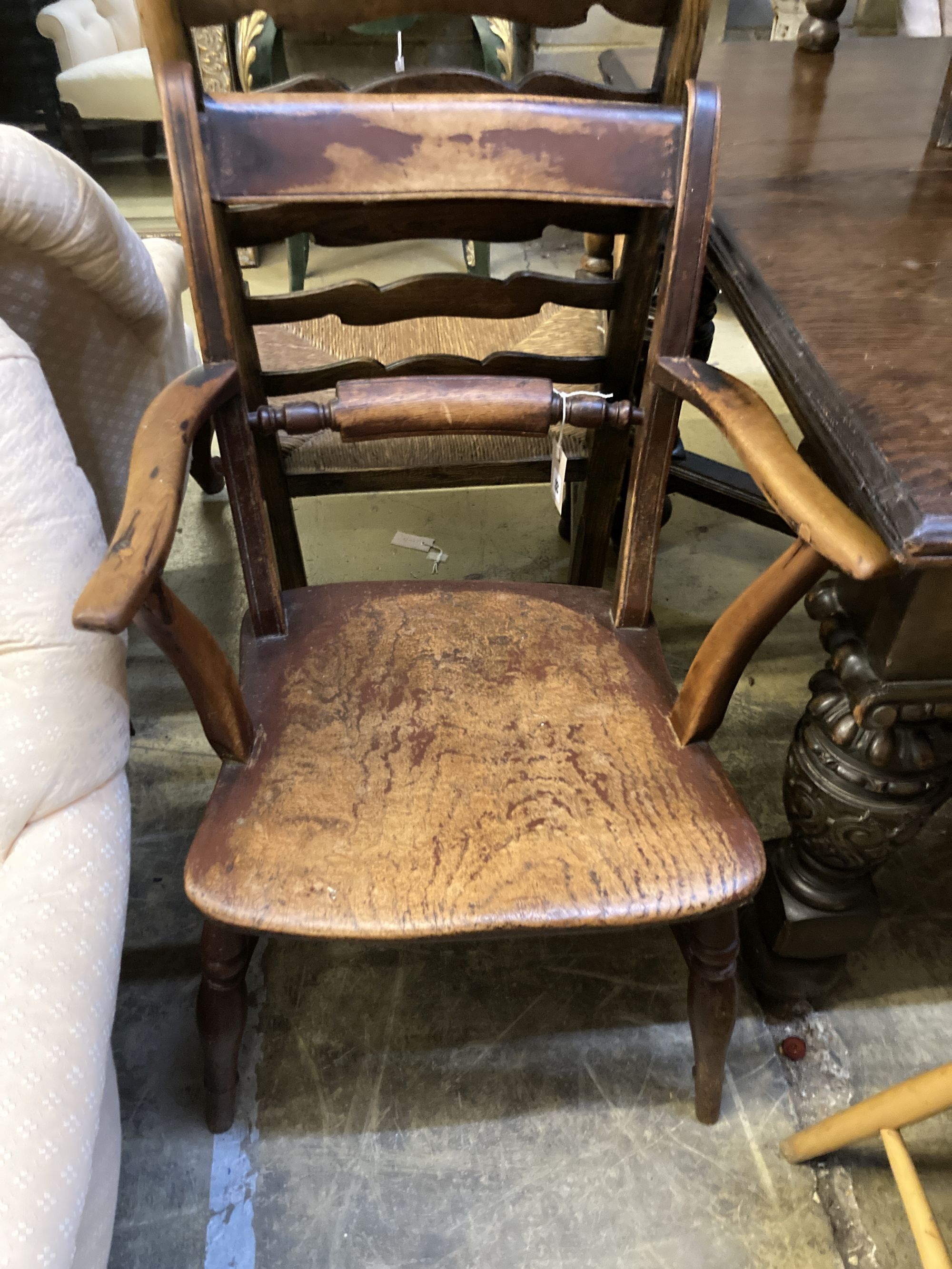 A 19th century ash and beech ladderback elbow chair and a spindle back elbow chair (2)